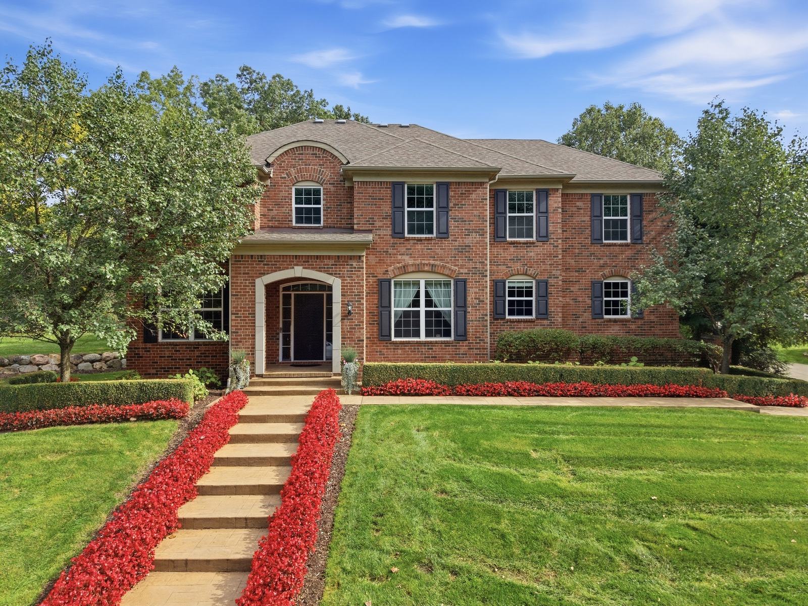 319 Greenan Lane, classic brick front with begonia-lined stone steps